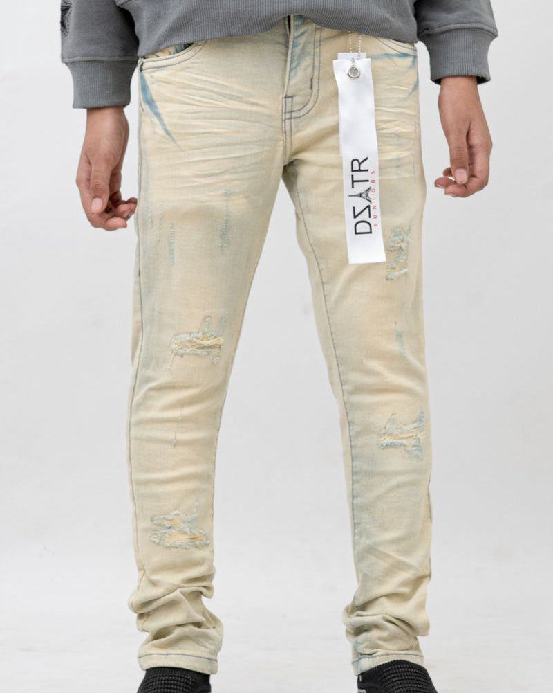 Light-colored distressed jeans with a brand tag on a white background