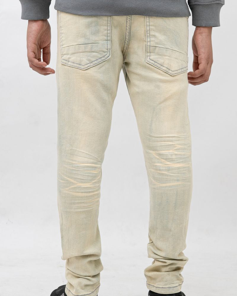 Person wearing light-colored jeans and a gray sweatshirt on a white background