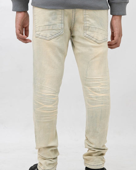 Person wearing light-colored jeans and a gray sweatshirt on a white background