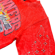 Red tank top with graphic design and rhinestone details on a white background