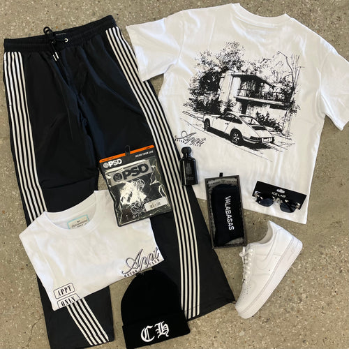 WHITE GRAPHIC TEE WITH BLACK NYLON JOGGERS SURROUNDED BY AIR FORCE 1'S AND ACCESSORIES