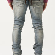 Person wearing light blue jeans and a purple top on a white background