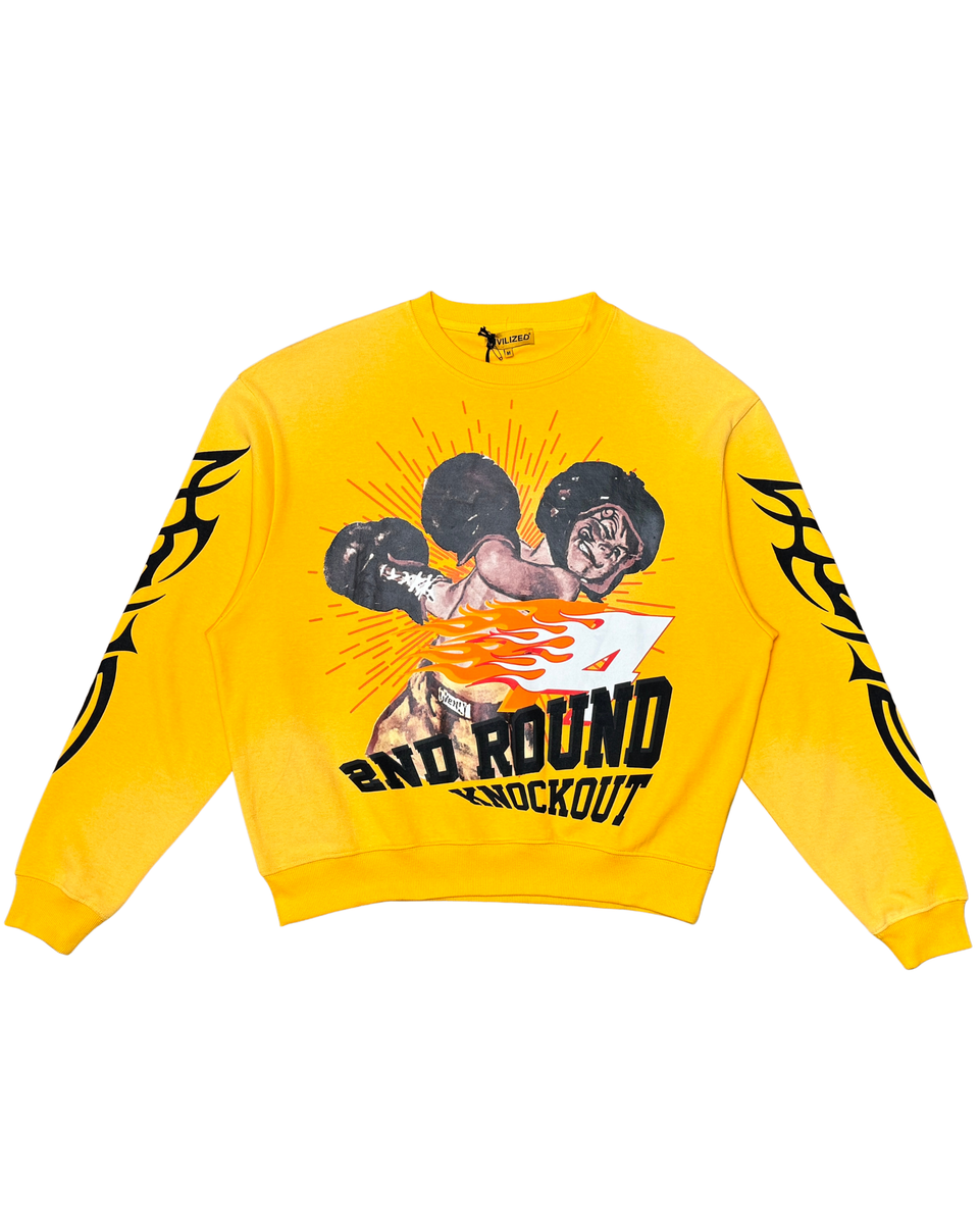 Yellow sweatshirt with boxing graphic and text on a white background