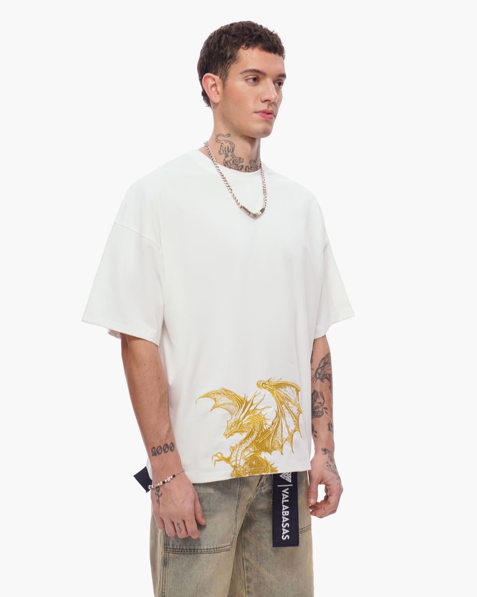 Man wearing a white t-shirt with a gold graphic design on a white background