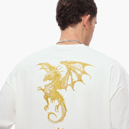 Person wearing a white t-shirt with a gold dragon design on the back against a white background