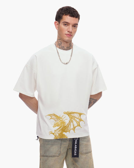 Man wearing a white t-shirt with a gold dragon design on a plain background