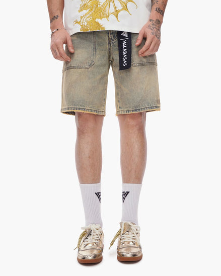 Person wearing light-colored denim shorts with a brand logo, white socks, and brown shoes on a white background.