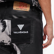 Black jeans with a visible brand logo and tag on a white background