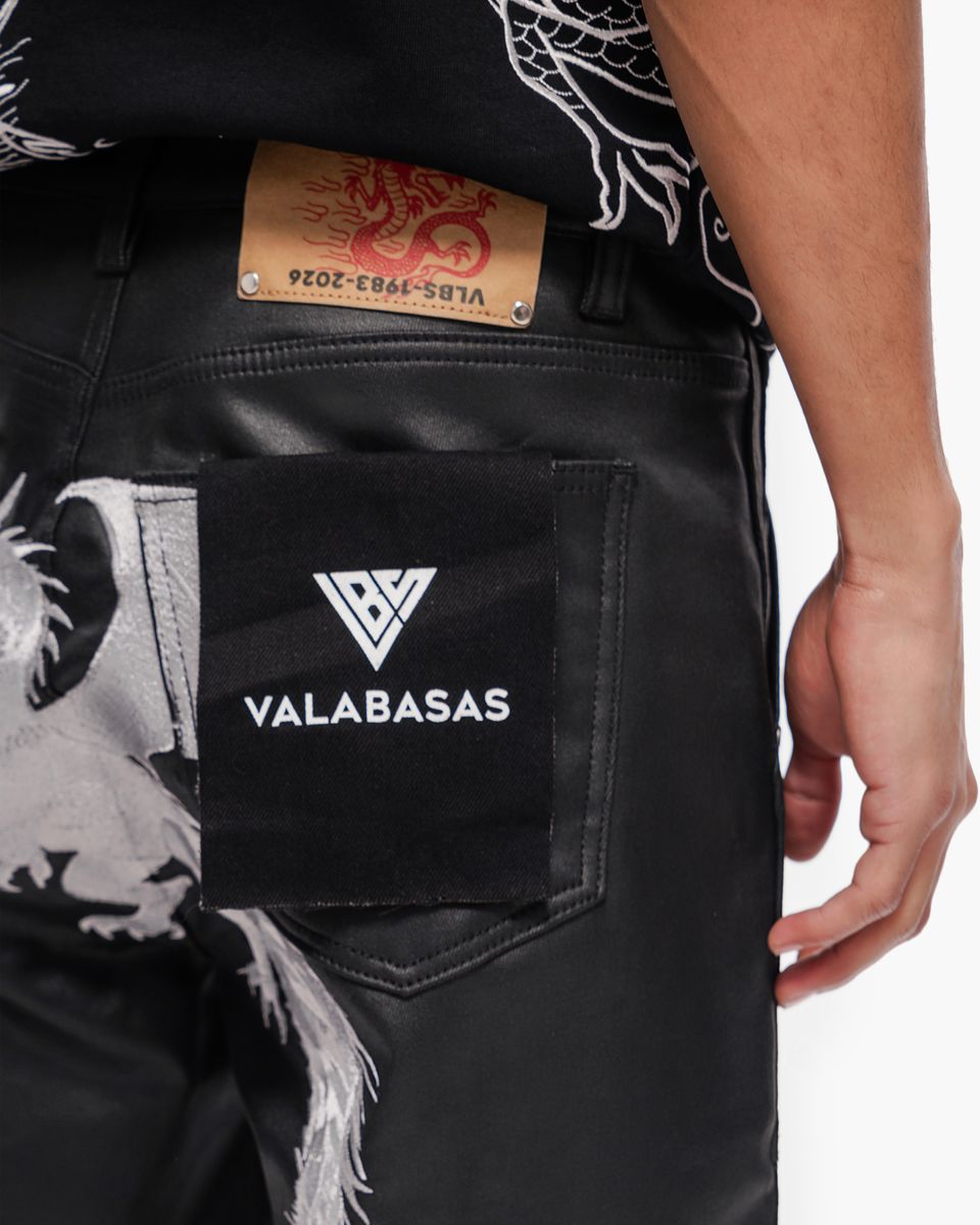 Black jeans with a visible brand logo and tag on a white background