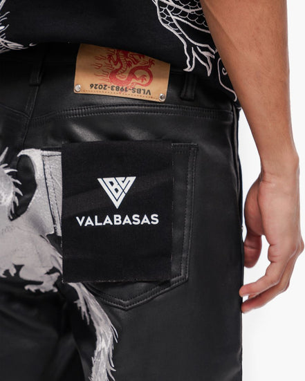 Black jeans with a visible brand logo and tag on a white background