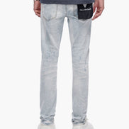 Light blue jeans with a brand label on the back pocket against a white background