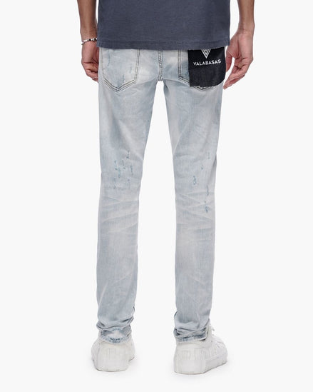 Light blue jeans with a brand label on the back pocket against a white background