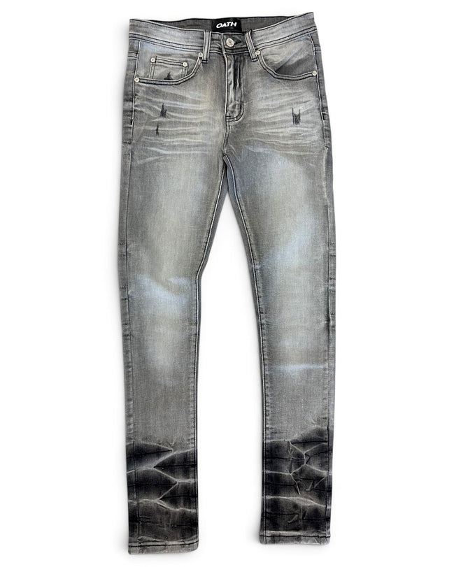 A pair of slim-fit denim jeans in a faded gray wash with a black acid-wash distressed finish at the hems, shown flat on a white background.