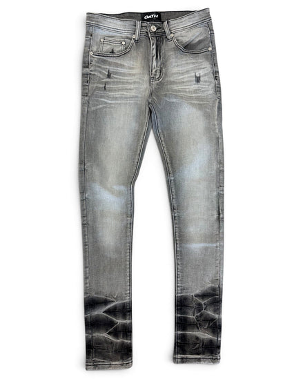 A pair of slim-fit denim jeans in a faded gray wash with a black acid-wash distressed finish at the hems, shown flat on a white background.