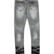 Gray denim jeans with a faded wash and a black reptile-scale pattern printed along the lower legs, shown from the back on a white background.