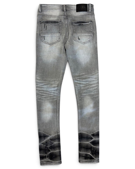 Gray denim jeans with a faded wash and a black reptile-scale pattern printed along the lower legs, shown from the back on a white background.