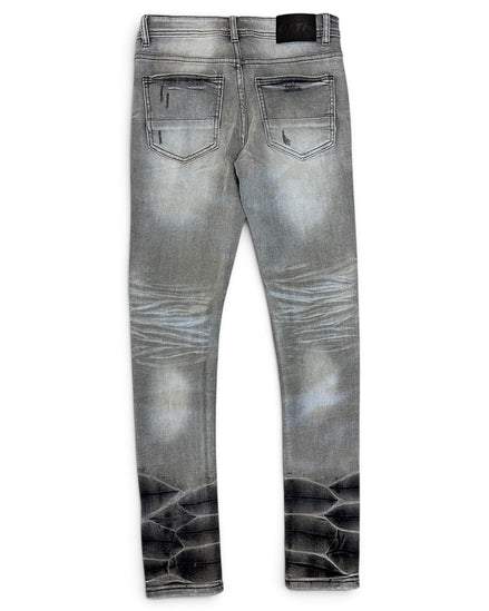 Gray denim jeans with a faded wash and a black reptile-scale pattern printed along the lower legs, shown from the back on a white background.