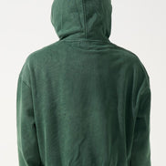 Green hoodie worn by a person on a white background