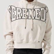 Person wearing a ivory hoodie with 'STEREOTYPE' text on a plain background