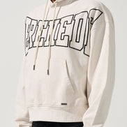 Person wearing a white hoodie with text design on a plain background