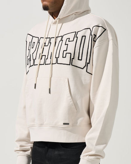 Person wearing a white hoodie with text design on a plain background