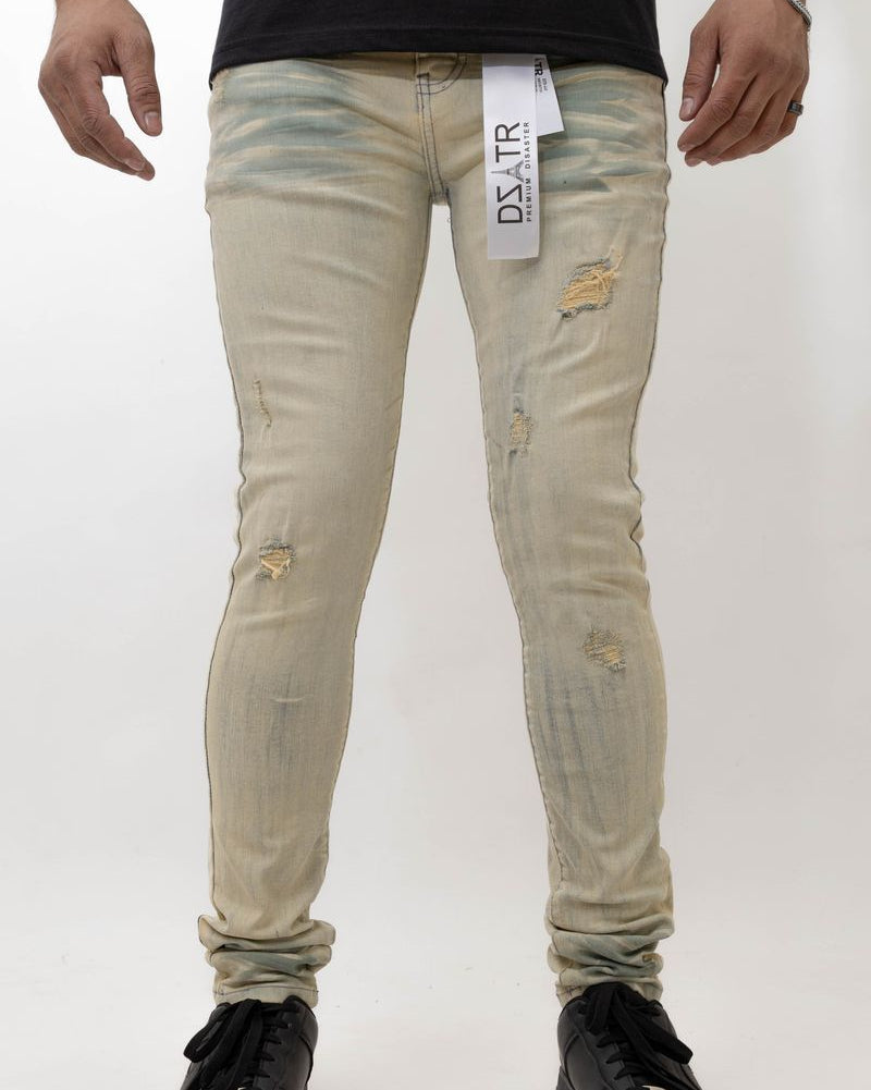 Beige distressed jeans worn by a person on a white background