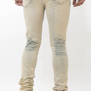 Beige distressed jeans worn by a person on a white background
