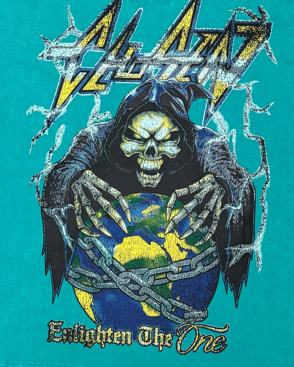 T-shirt with a graphic of a skeleton holding a world map, surrounded by text and symbols on a teal background.