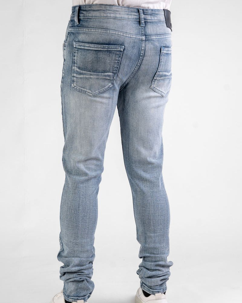 Light blue jeans worn by a person on a white background
