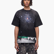 Person wearing a black t-shirt with a graphic design on a white background