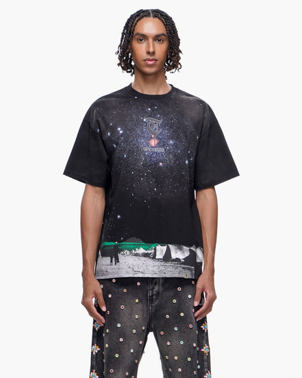 Person wearing a black t-shirt with a graphic design on a white background