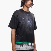 Person wearing a black t-shirt with a graphic design on a white background
