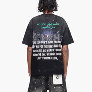 Person wearing a black t-shirt with text on the back, standing against a white background