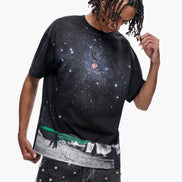 Person wearing a black t-shirt with a graphic design on a white background