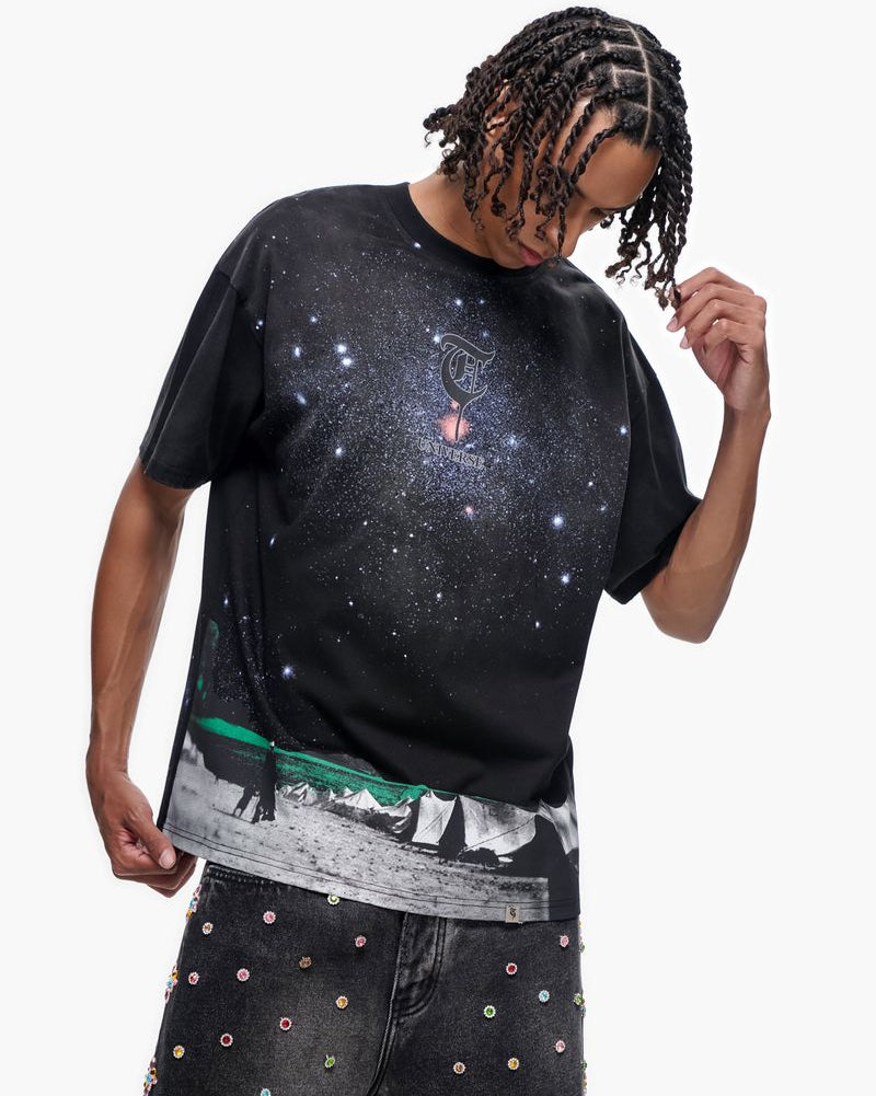 Person wearing a black t-shirt with a graphic design on a white background