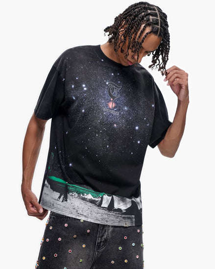 Person wearing a black t-shirt with a graphic design on a white background