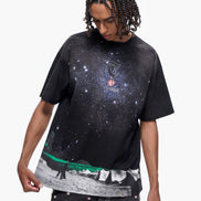 Person wearing a black t-shirt with a galaxy design on a white background