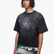Person wearing a black t-shirt with a graphic design on a white background