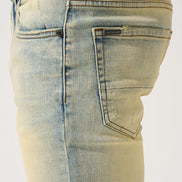 Light blue denim jeans with a brand logo on a white background