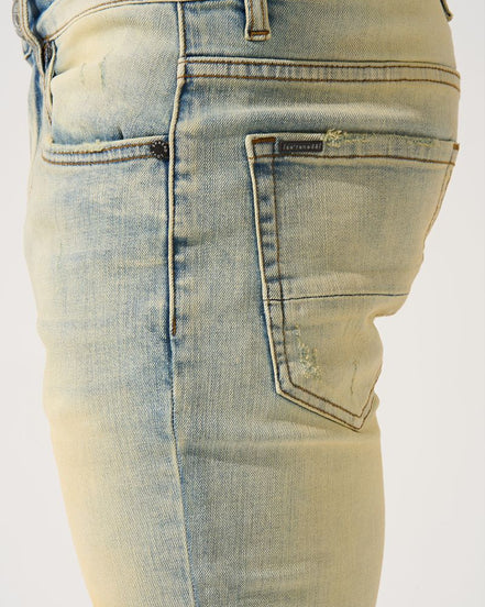 Light blue denim jeans with a brand logo on a white background