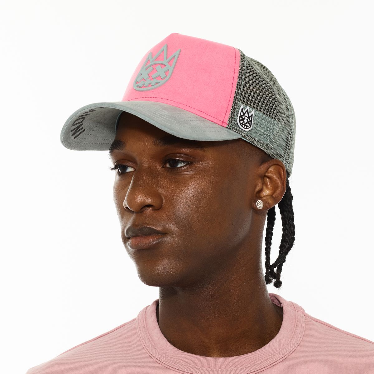 Person wearing a pink and gray cap on a white background