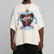 Person wearing a white t-shirt with a colorful graphic design on a gray background