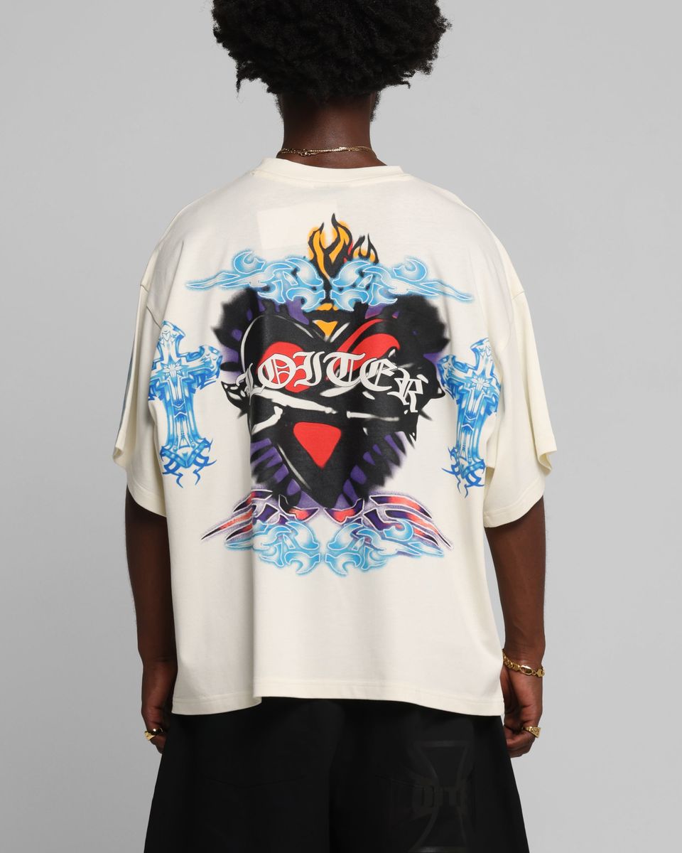 Person wearing a white t-shirt with colorful graphic design on the back against a gray background