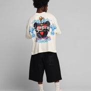 Person wearing a white t-shirt with a colorful graphic design on a gray background