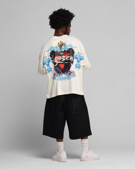 Person wearing a white t-shirt with a colorful graphic design on a gray background