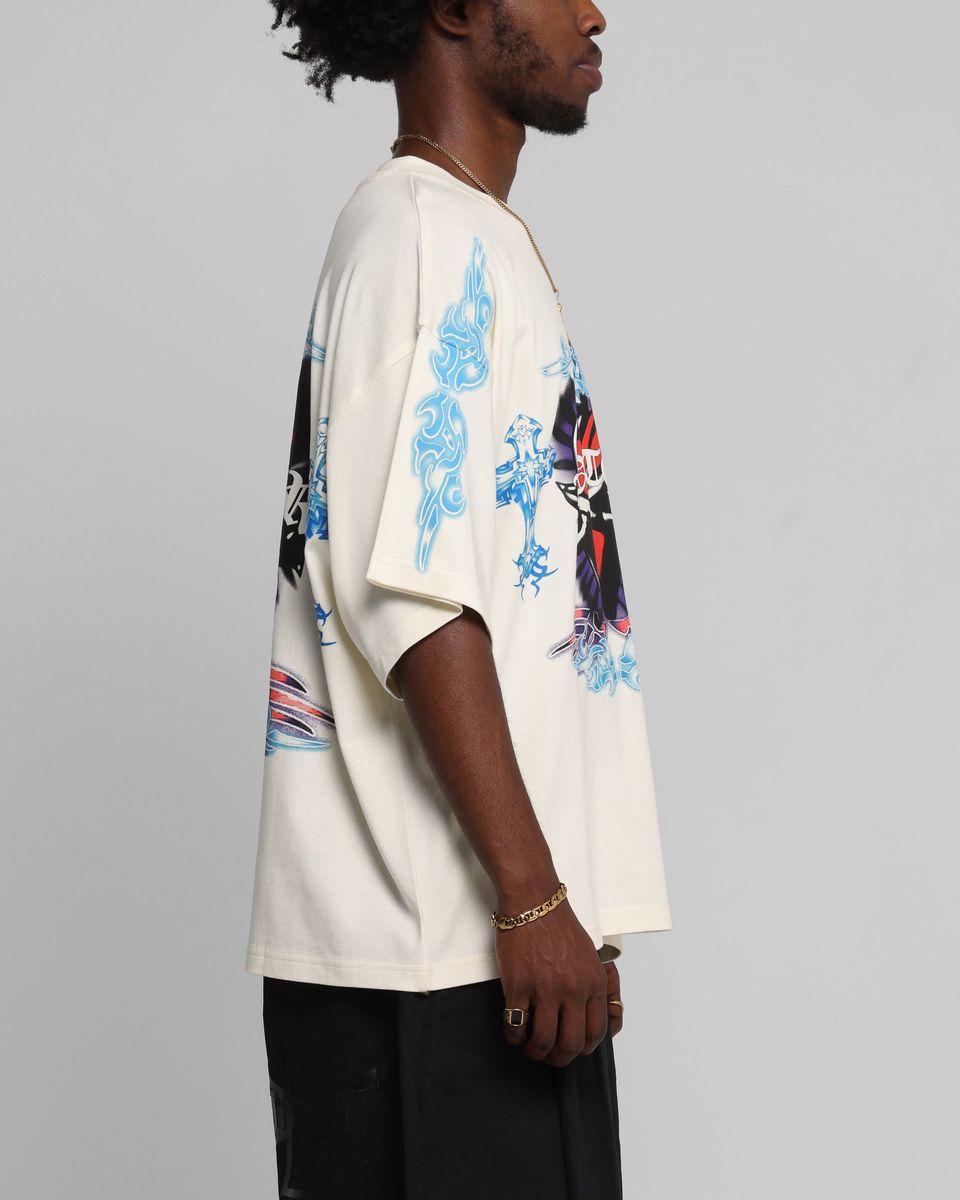 Person wearing a white shirt with blue and red designs on a gray background