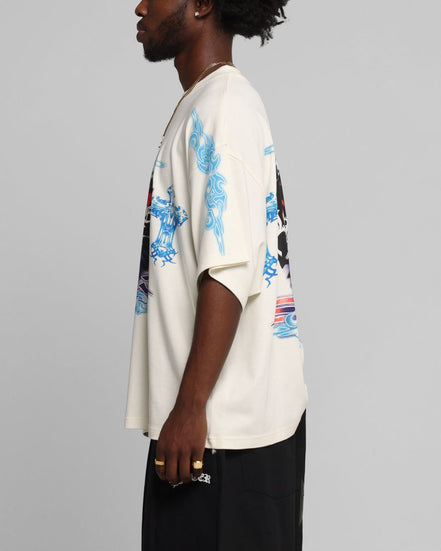 Person wearing a white t-shirt with blue floral patterns on a gray background