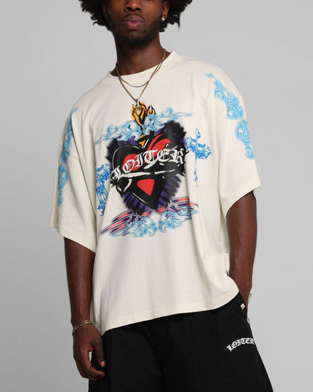 Person wearing a white t-shirt with colorful graphic design on a gray background