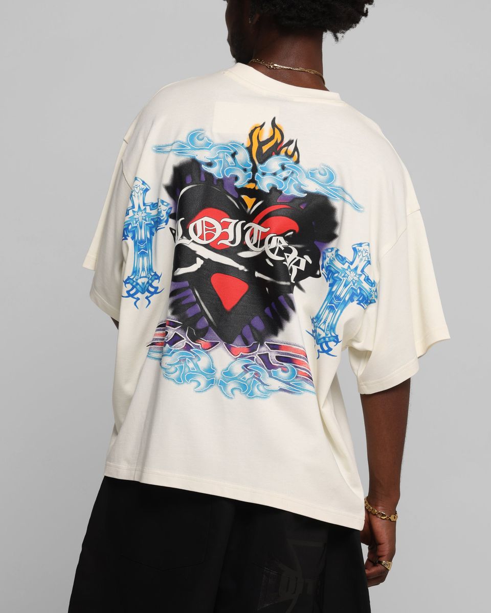 Person wearing a white t-shirt with colorful graphic design on a gray background