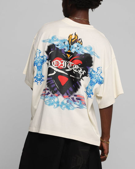 Person wearing a white t-shirt with colorful graphic design on a gray background